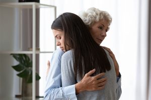 Supportive mom hug sad depressed adult daughter