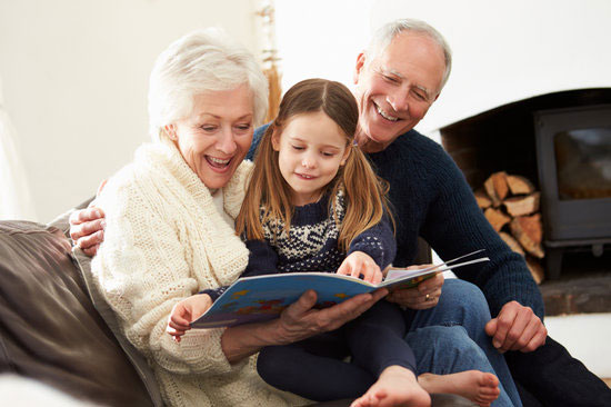 Grandparents reading a story to grandchild.